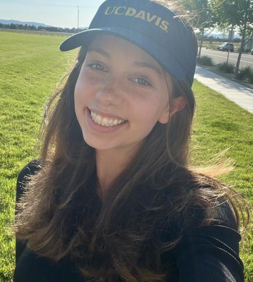 Erin wearing a UC Davis visor.