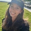Erin wearing a UC Davis visor.