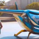 Student walking next to airplane.