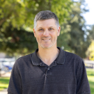 Photo of Sam King. He is a white male wearing a black polo shirt.